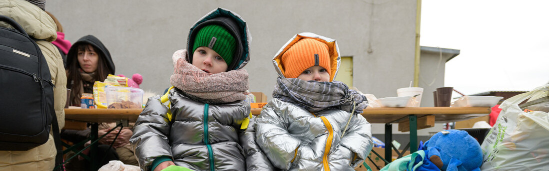 Refugee children from Ukraine sitting on a bench Refugee children from Ukraine sitting on a bench