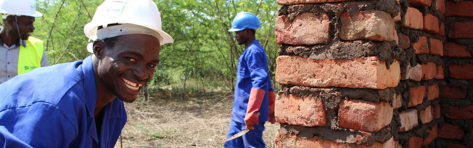 Ein Maurer baut in Malawi ein stabiles Haus aus Stein und Zement