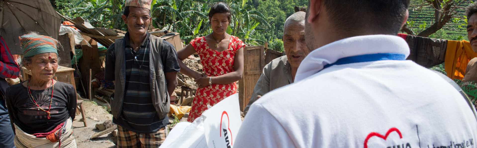 Ein Helfer von AWO International spricht mit Menschen in Nepal