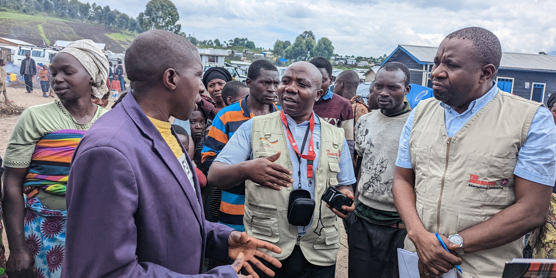 Helfer der Johanniter sprechen mit Geflüchteten in einem Camp in der DR Kongo