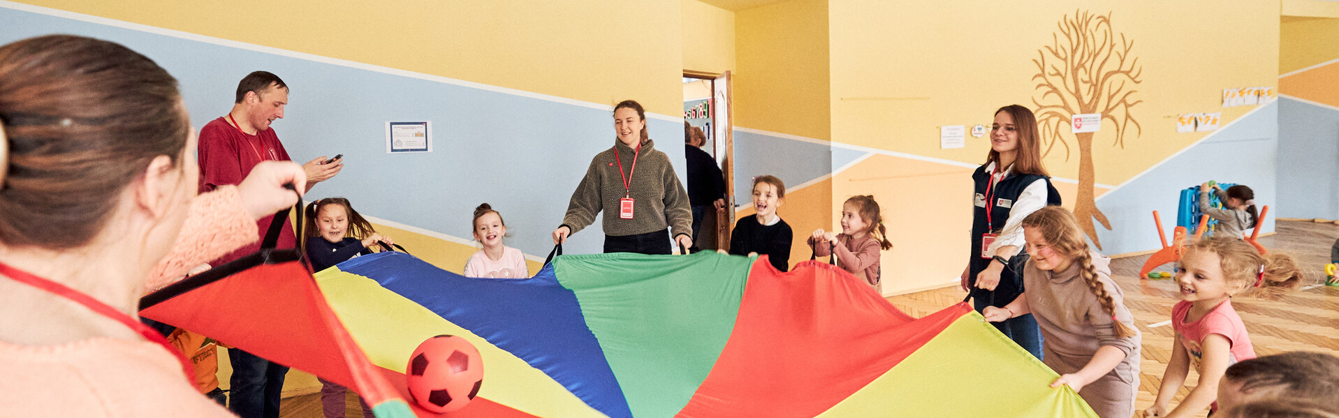 Kinder aus der Ukraine balancieren einen Ball in einem bunten Tuch