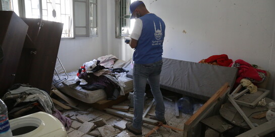 Ein Helfer von Islamic Relief macht sich in einer zerstörten Wohnung in Beirut Notizen über die Schäden  