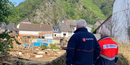 Helfer der Malteser blicken auf den von der Flut überschwemmten Ort Mayschoss im Ahrtal