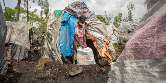 Madame Bora Kubuya in einem Camp in der DR Kongo mit ihrer Essensration, die sie von der Hilfsorganisation CARE erhalten hat