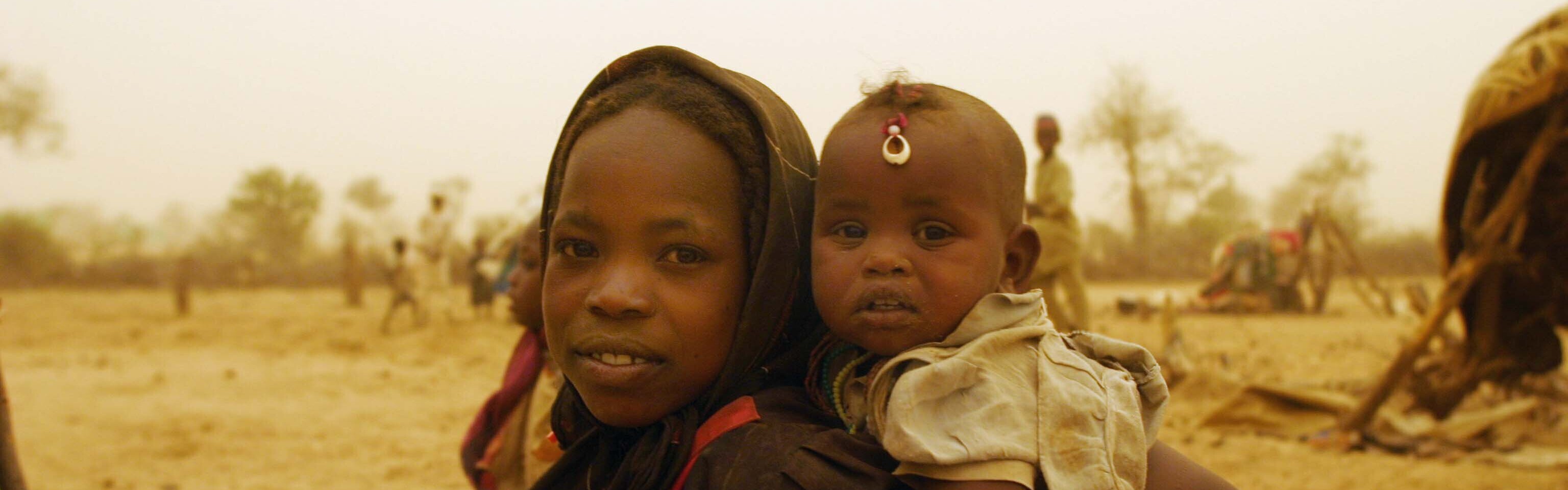 Während einer Dürre im Tschad trägt ein Mädchen ein Baby durch die Wüste. Die Auswirkungen von El Niño treffen die Länder im Osten Afrikas schwer.