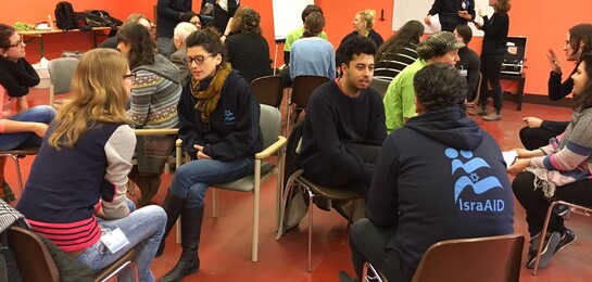 Menschen diskutieren in einem Raum.