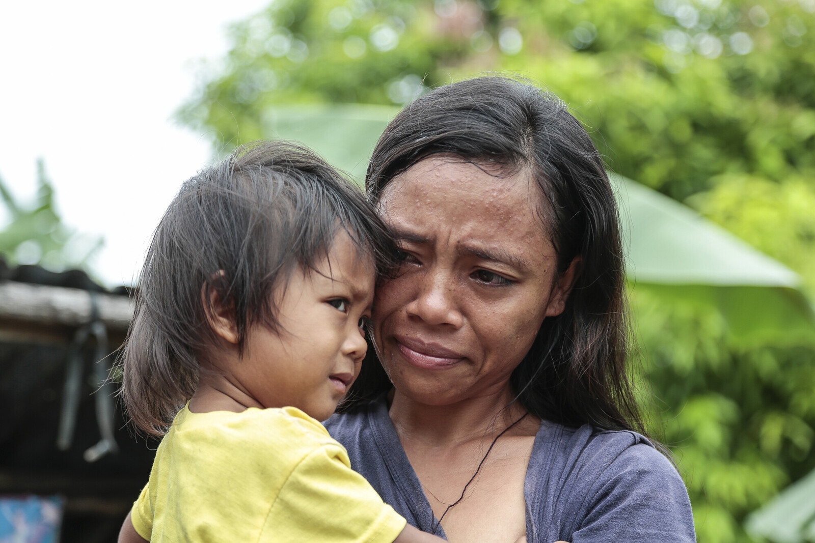 Frau und Kind nach Wirbelsturm Taifun Haiyan auf den Philippinen