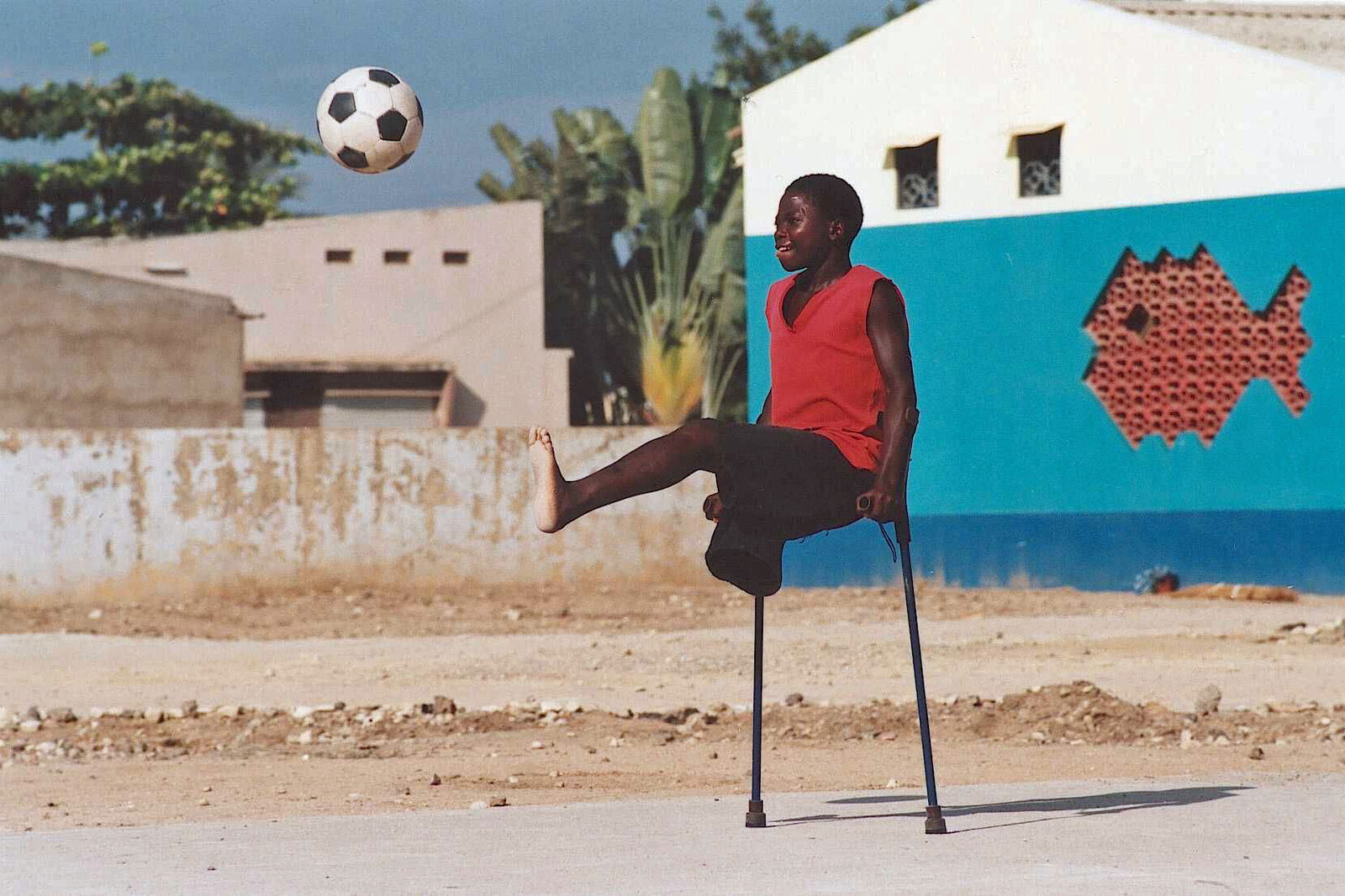 Angola: Ein Junge mit Behinderung spielt Fußball