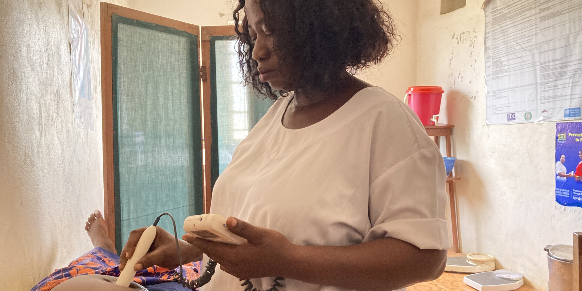 Aminata ist Hebamme in Sierra Leone und untersucht eine schwangere Frau Aminata ist Hebamme in Sierra Leone und untersucht eine schwangere Frau