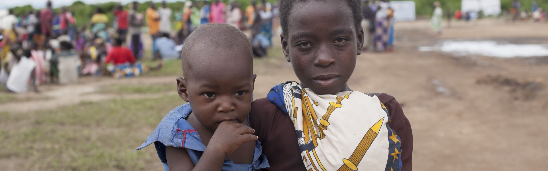 Mädchen hält Kind in Malawi auf dem Arm nach dem Zyklon Idai