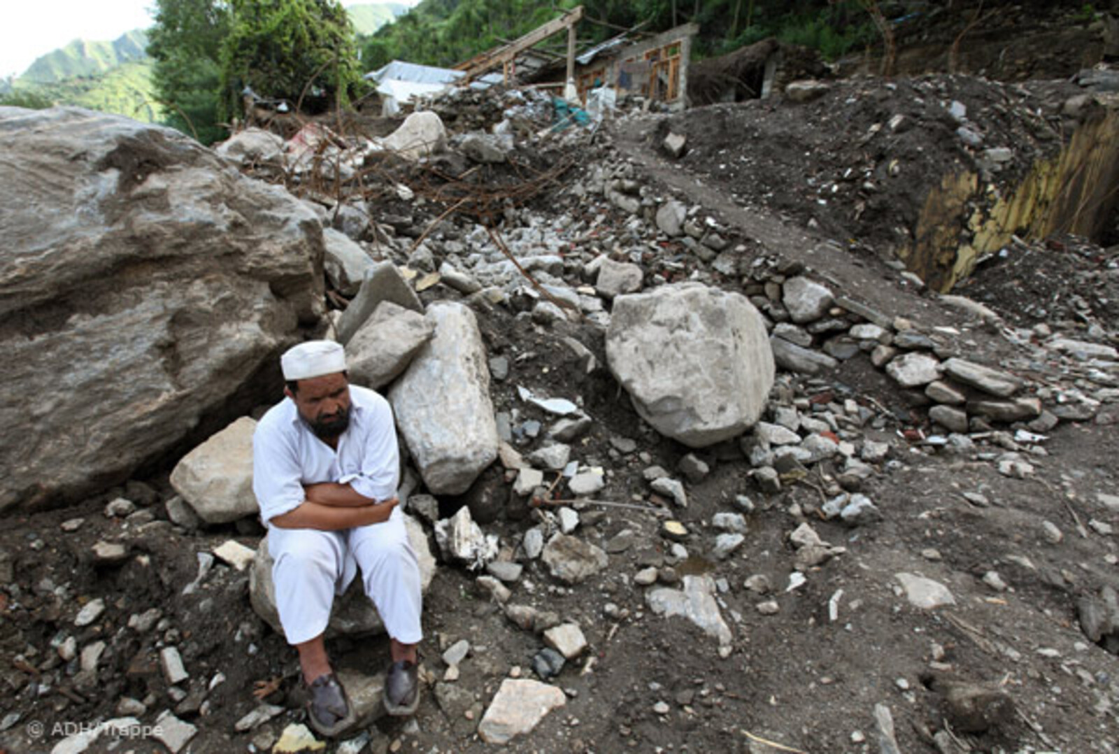 028pakistan-trappe-mann-ruinen Flut Pakistan: Mann sitzt auf Bergen von Schutt