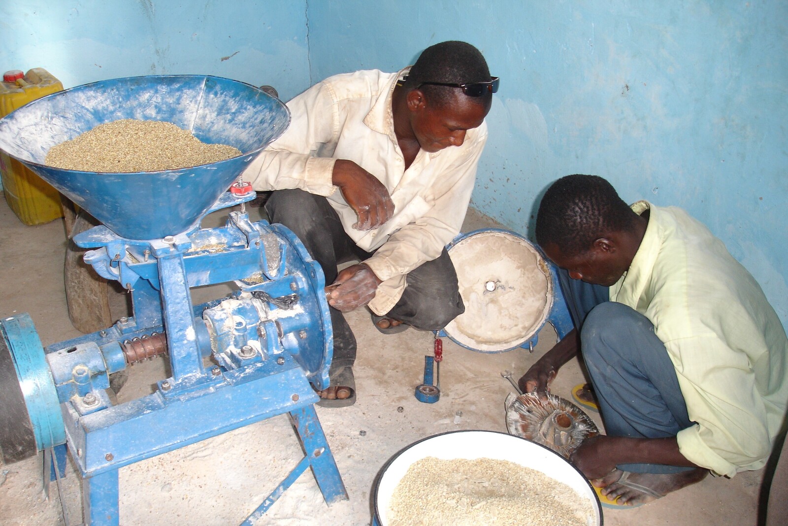 Männer mahlen aus dem Getreide Mehl. Aus diesem wird dann das Brot für die Gemeinde gebacken, welches gerecht an alle verteilt wird.