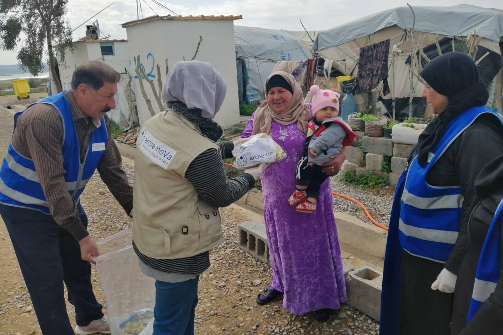 Zum Schutz vor Corona: Eine Frau und ihr Baby erhalten im Irak ein Hygieneset