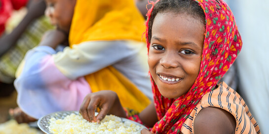 Die Hilfsorganisation World Vision unterstützt geflüchtete Kinder aus dem Sudan im Farchana Refugee Camp in Tschad mit Essen
