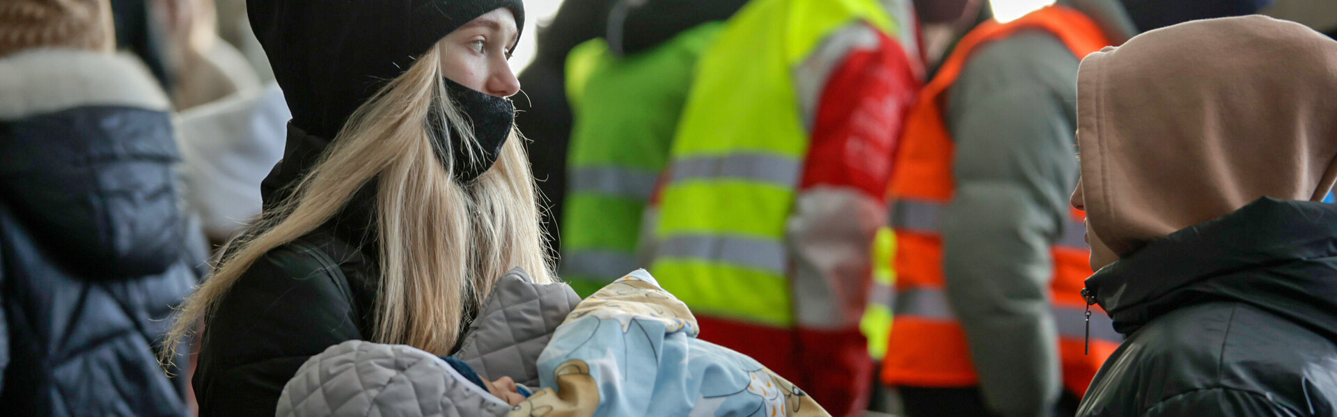 Eine vor dem Krieg in der Ukraine geflüchtete Frau hält ihr Kind in den Armen