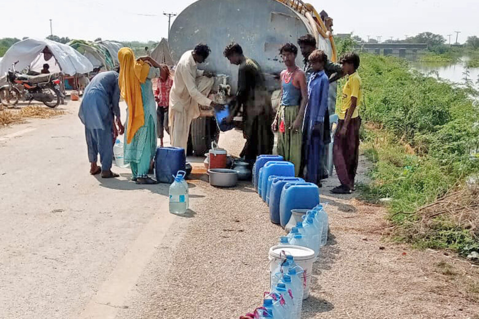Menschen bei einer Trinkwasserausgabe in Pakistan