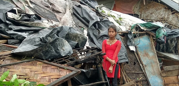 Nach dem Wirbelsturm: ein Kind vor zerstörten Häusern in Indien