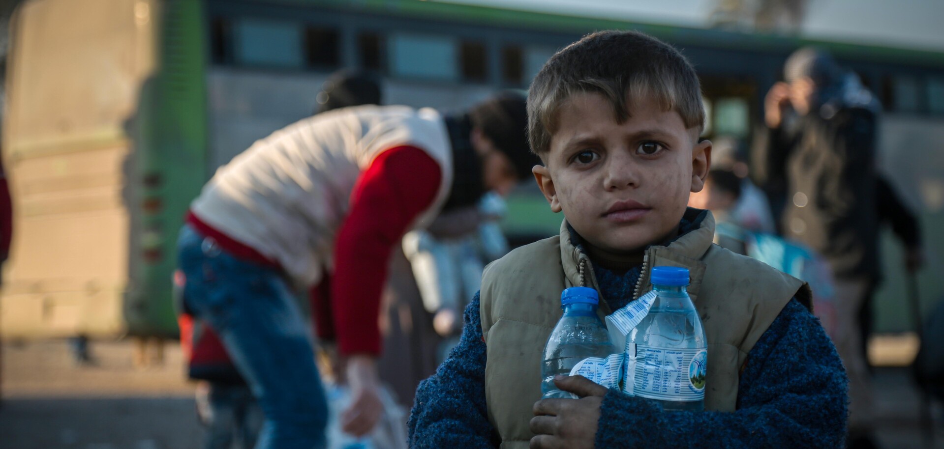 Ein Junge steht mit seiner Wasserration in Aleppo. Ein Junge steht mit seiner Wasserration in Aleppo.