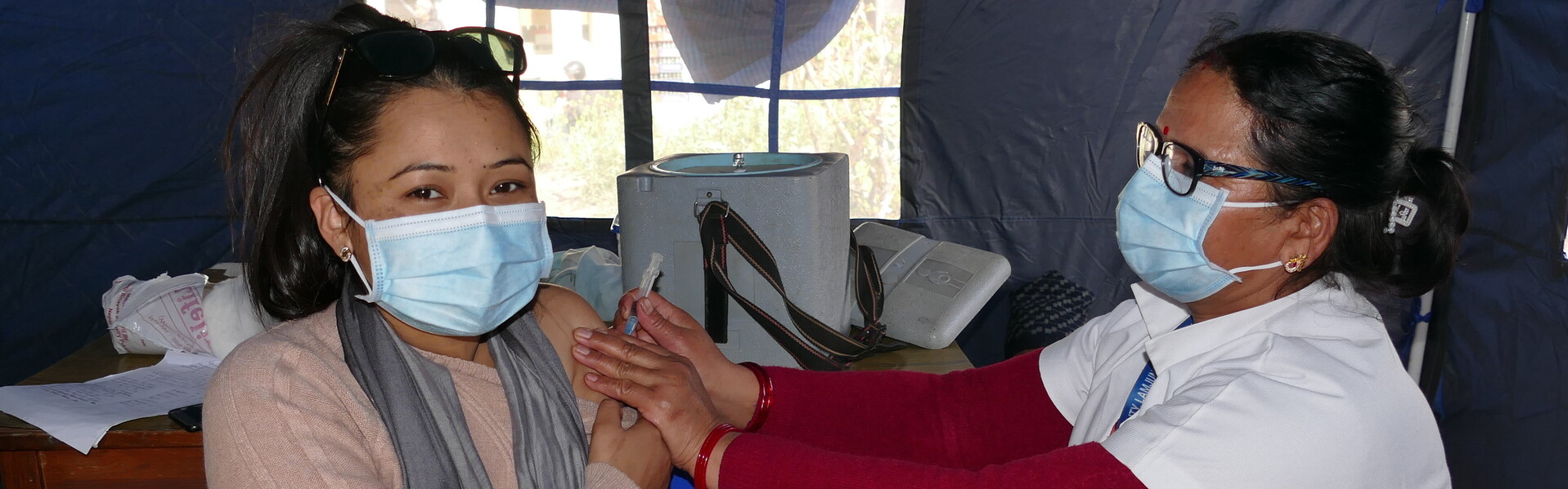 Eine Ärztin in Nepal impft eine Frau