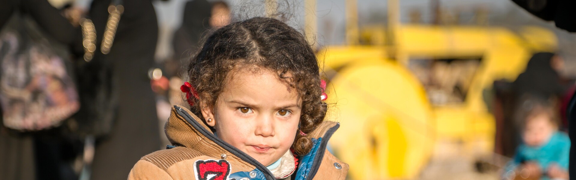 Kleines Mädchen mit Winterjacke in einem Flüchtlingscamp in Syrien