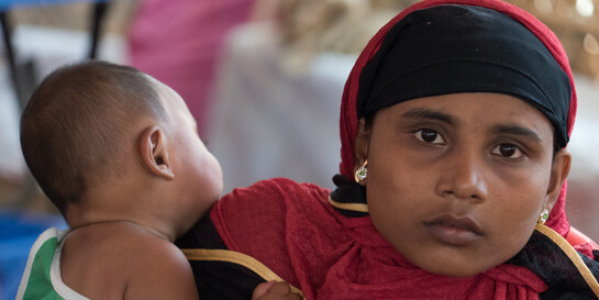 Eine Mutter in Bangladesch hält ihr Baby schützend auf dem Arm