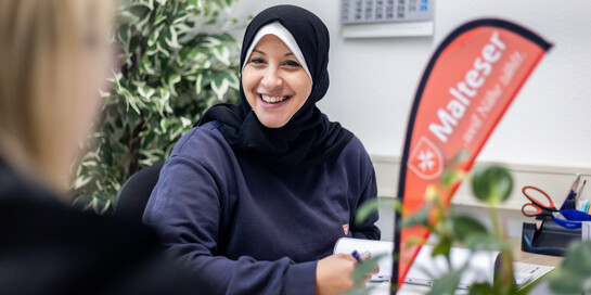 Eine Helferin der Malteser berät nach der Flut in Deutschland eine Frau