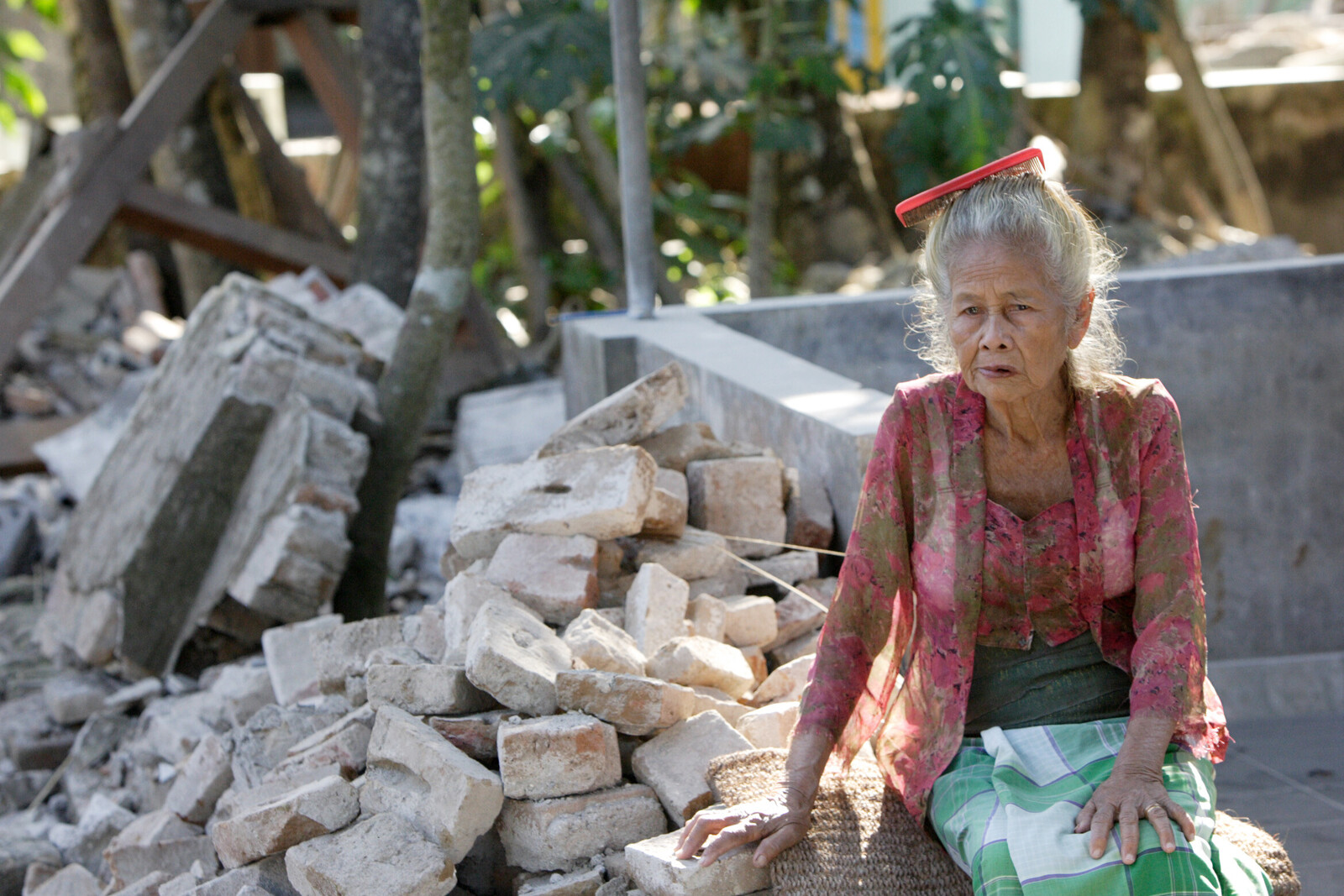 Eine Frau neben den Trümmern eines Haus, das durch ein Erdbeben zerstört wurde (Archivfoto)