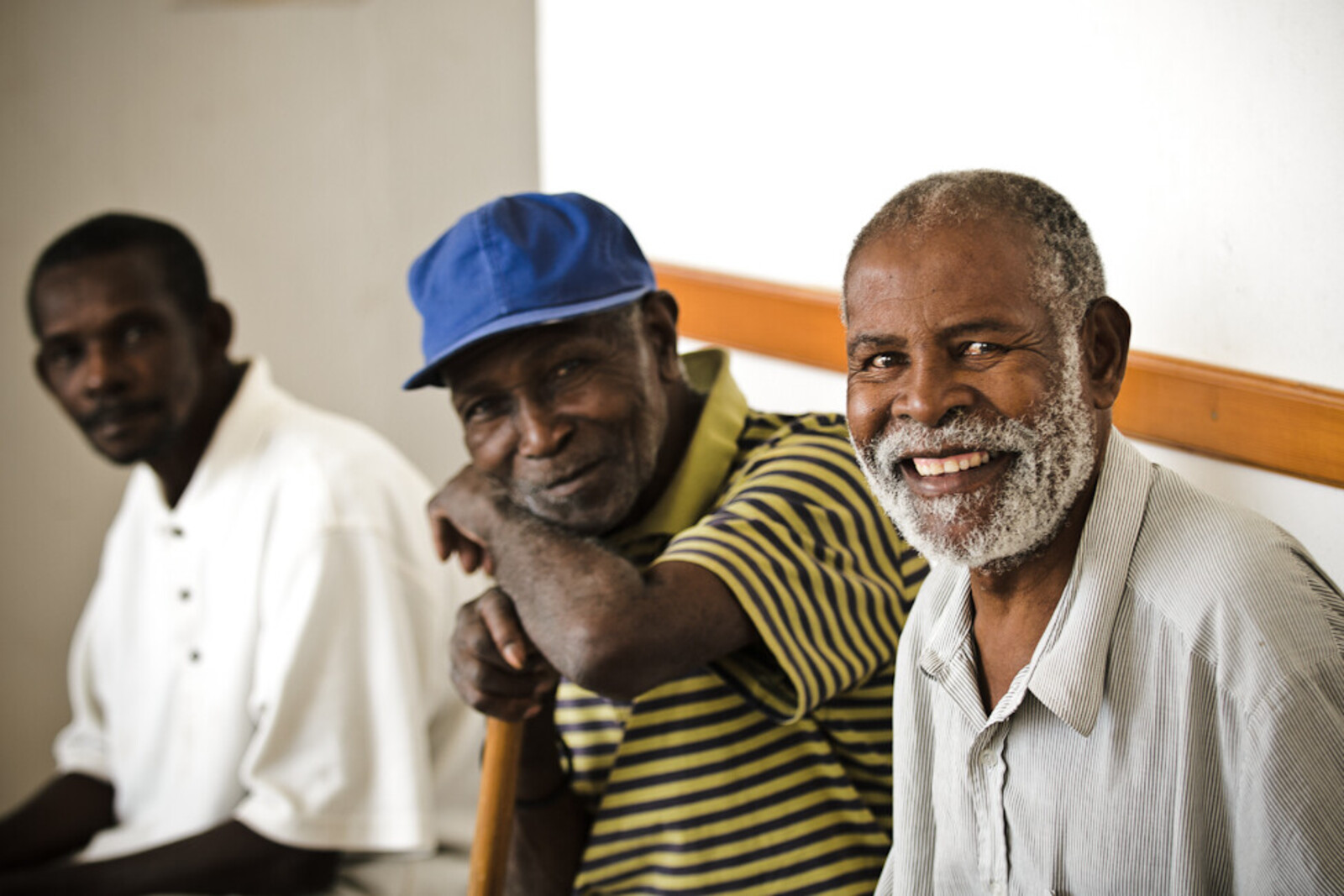Three old men sit in a house in Africa