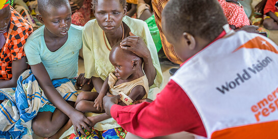 Ein Helfer von World Vision mit Familien im Südsudan