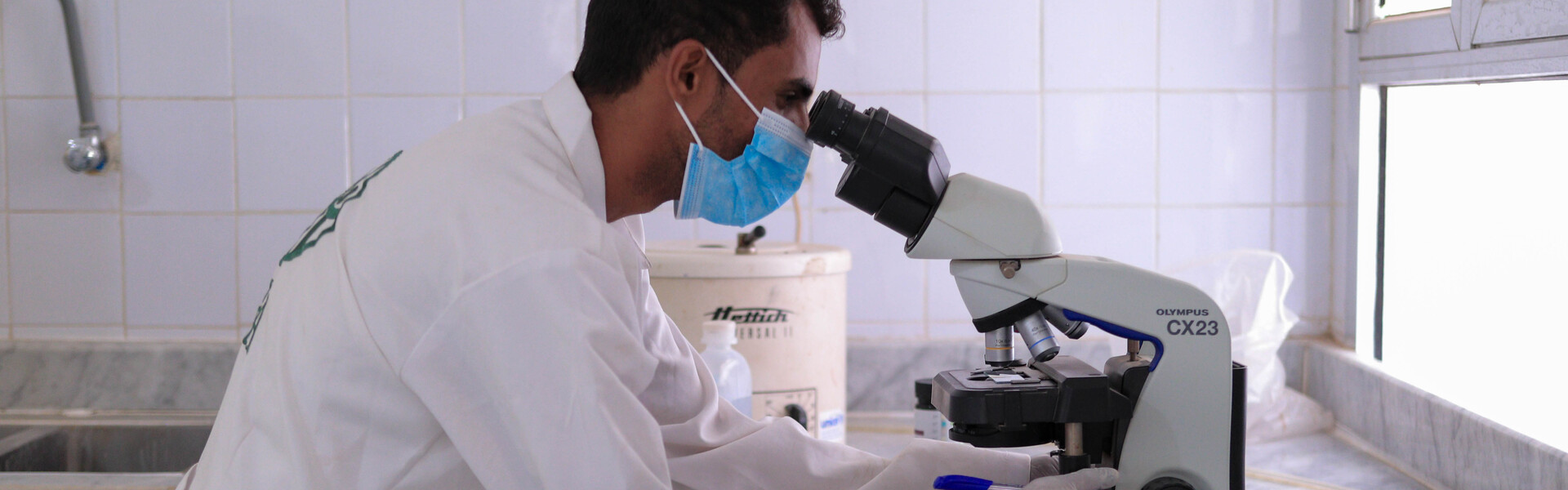 Ein Arzt untersucht im Jemen eine medizinische Probe am Mikroskop Ein Arzt untersucht im Jemen eine medizinische Probe am Mikroskop