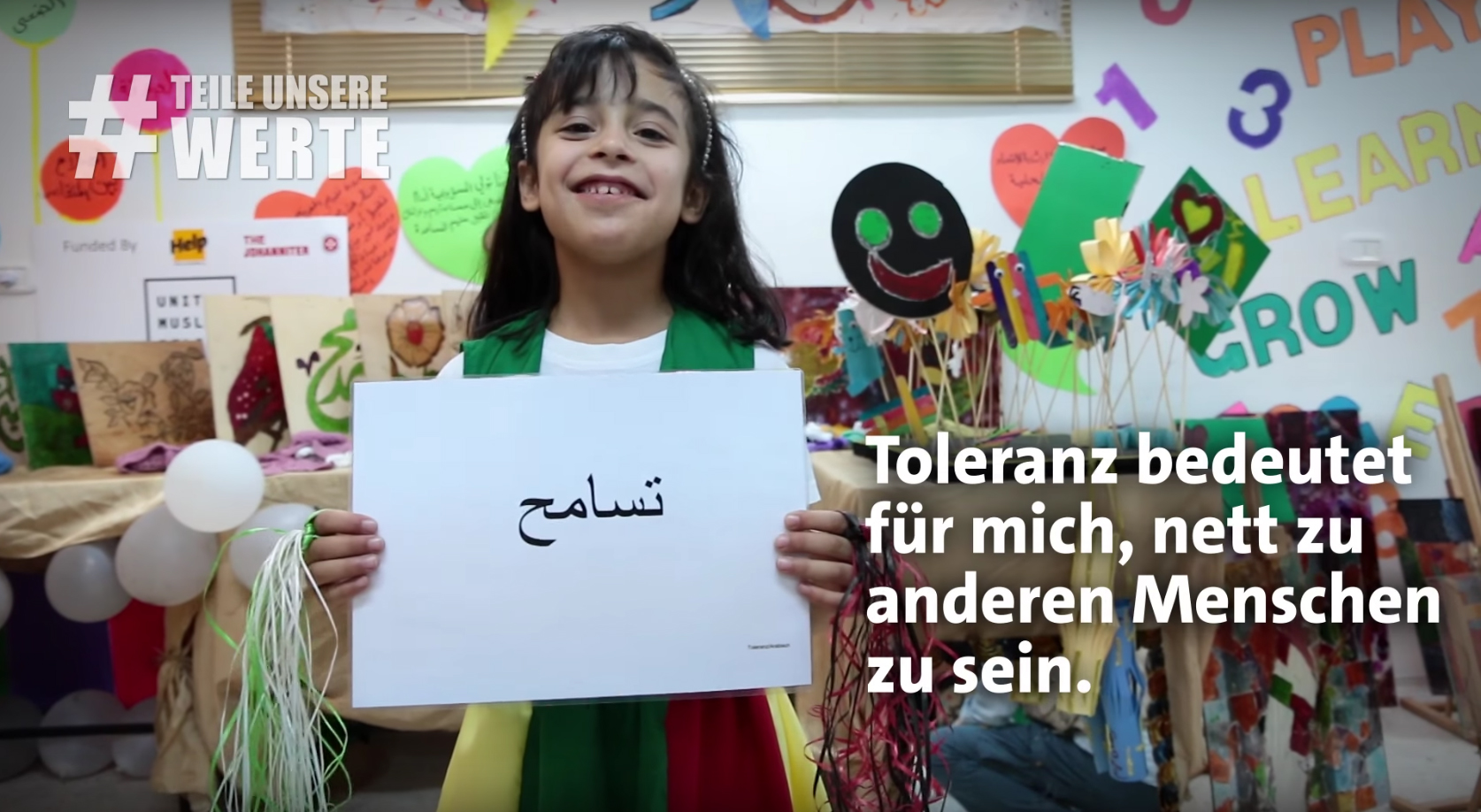 Kind hält Schild hoch mit der Aufschrift Toleranz.