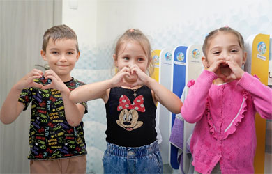 Drei Kinder in der Ukraine formen mit ihren Händen ein Herz